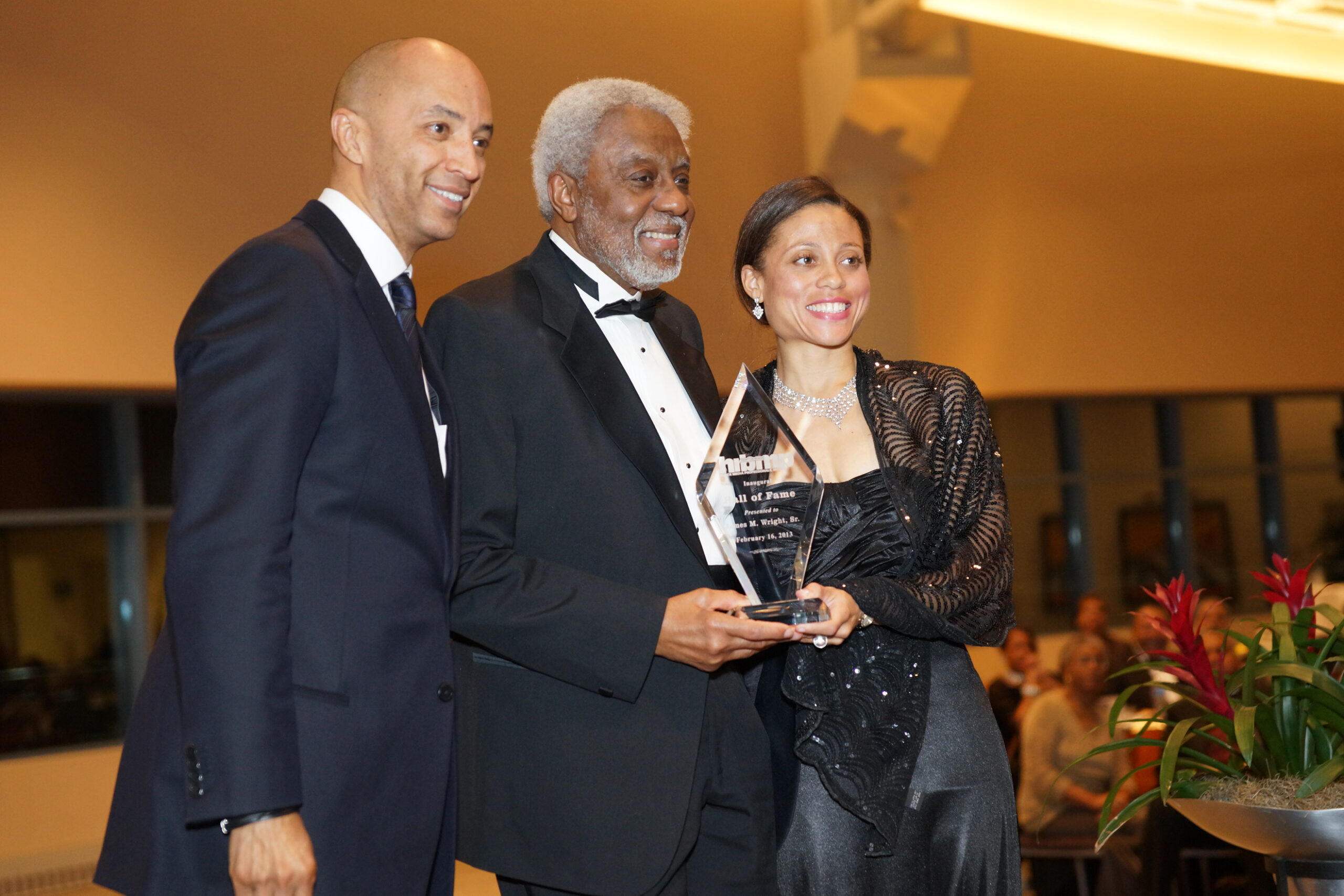Cheryl and Byron Pitts, ABC News Nightline co-anchor, present an HRBMP Hall of Fame award to late HRBMP founder James M. Wright.
